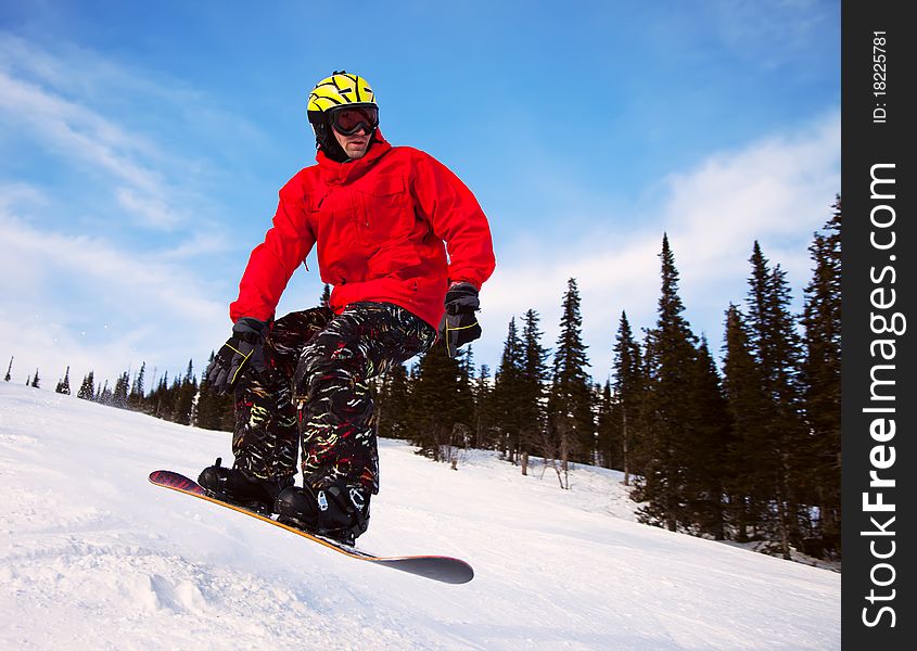 Snowboarder jumping through air with deep blue sky in background