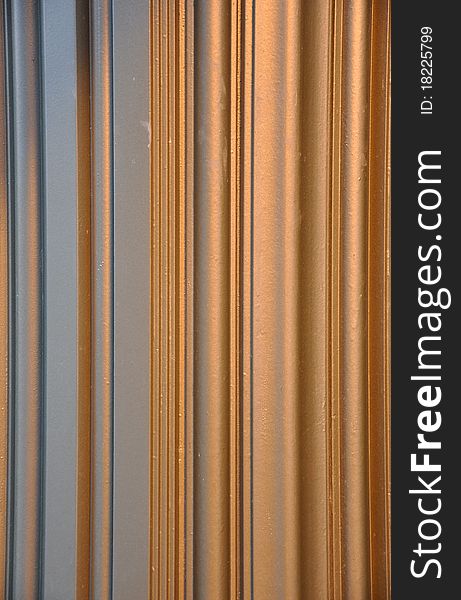 A copper and gray vertical striped pattern. A copper and gray vertical striped pattern