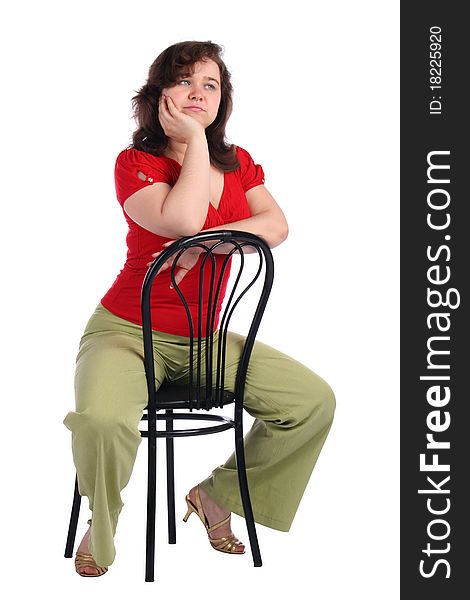 Chubby girl sits on stool dreaming. Isolated on white.