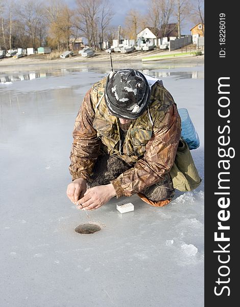 Ice fishing competition. competitor catches the fish on Ice Fishing Jig with bloodworm. Ice fishing competition. competitor catches the fish on Ice Fishing Jig with bloodworm