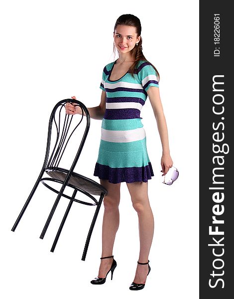 Girl in stripy blue dress holds stool. Isolated on white.