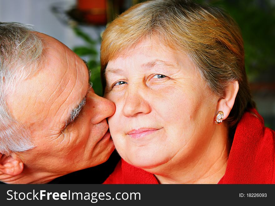 Happy senior lovely couple kissing. Happy senior lovely couple kissing