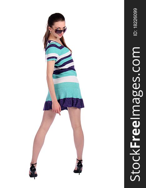 Girl in stripy blue dress turns around. Isolated on white.