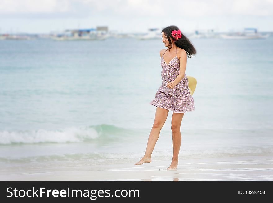 Young attractive woman walking on beach. Young attractive woman walking on beach