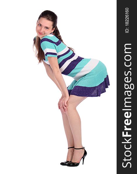 Girl in stripy blue dress bend forward side-view. Isolated on white.