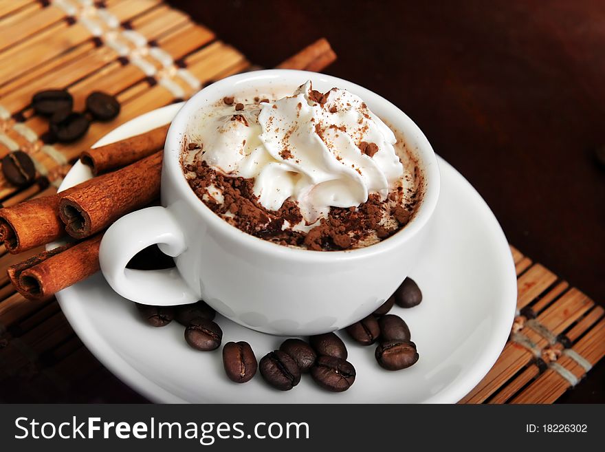 Cup of coffee with cream and cinnamon