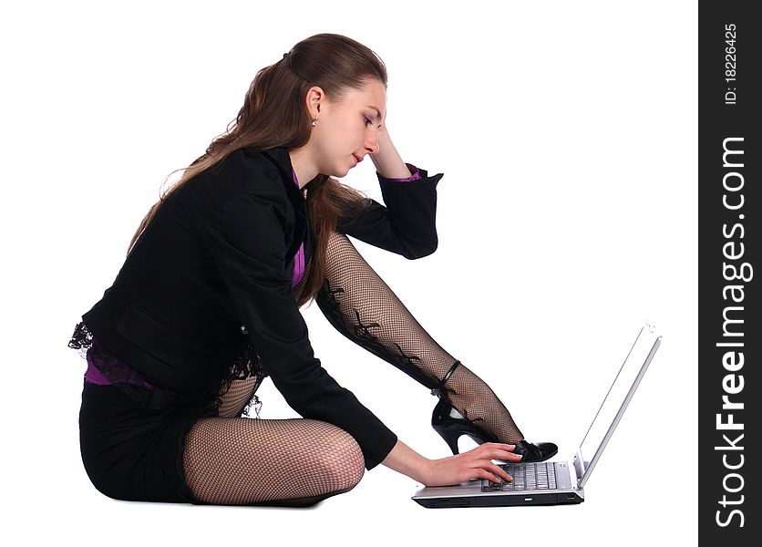 Girl in black suit sits on floor and works with notebook. Isolated on white. Girl in black suit sits on floor and works with notebook. Isolated on white.