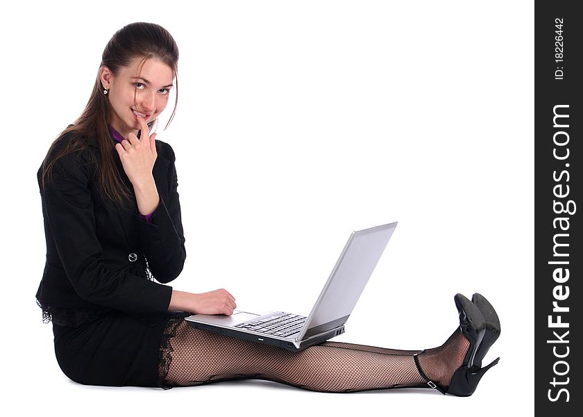 Girl in black suit with notebook sit on floor. Isolated on white.