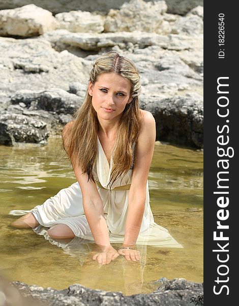 Attractive Young Woman Sitting In The Water