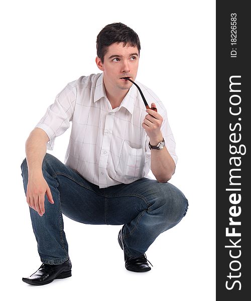 Young man with pipe sits. Isolated on white.