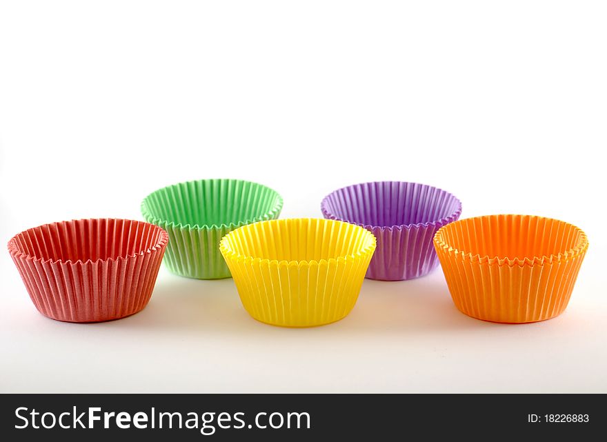 Five different colored cake cups isolated on a white background