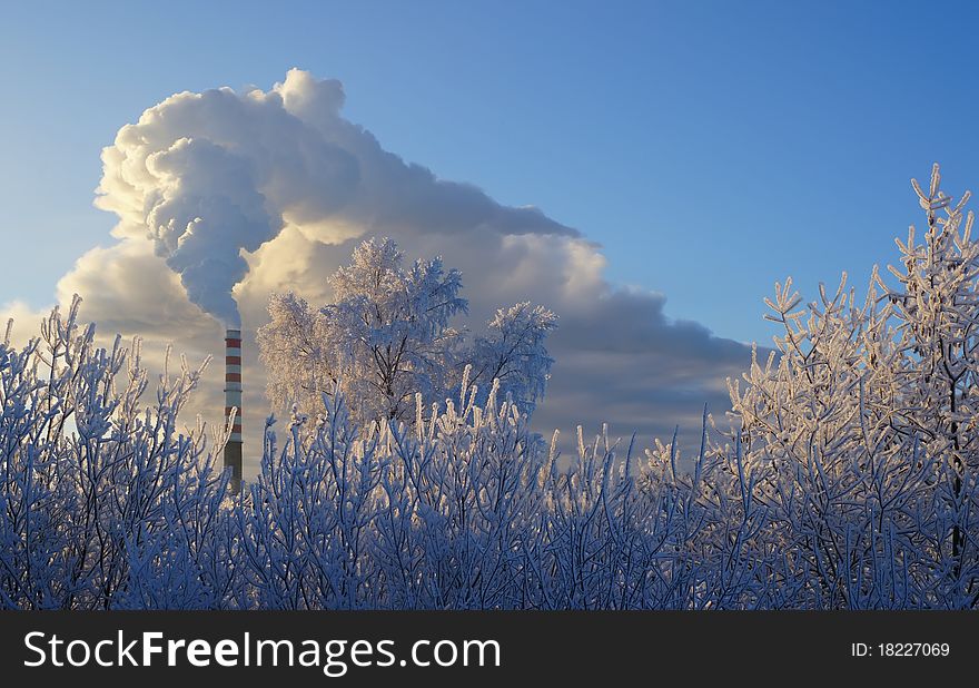 Smoke from the chimney of the gas thermal power station on a frosty day