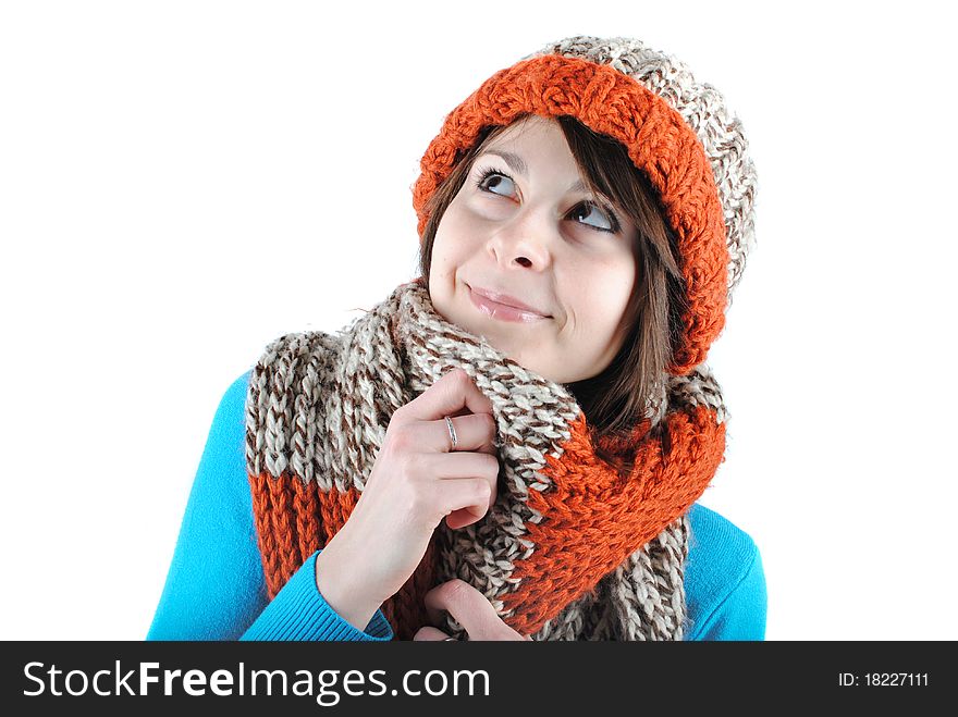 Happy beautiful girl wearing a hat and scarf isolated against white background