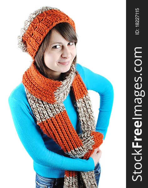 Happy beautiful girl wearing a hat and scarf isolated against white background