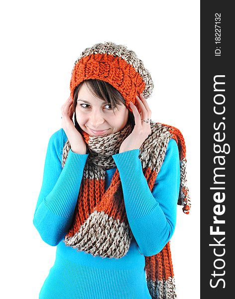 Happy beautiful girl wearing a hat and scarf isolated against white background