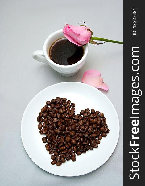 Cup of coffee with heart from coffee beans