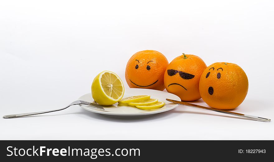 Oranges with a plate with knife and fork and lemon. Oranges with a plate with knife and fork and lemon
