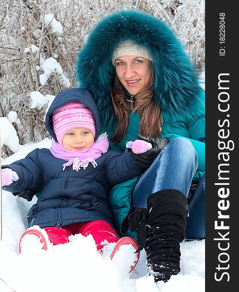 Mother And  Kid Having Fun Outdoors On  Winter Day