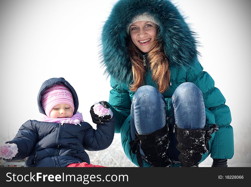 Mother and kid having fun outdoors on beautiful winter day. Mother and kid having fun outdoors on beautiful winter day