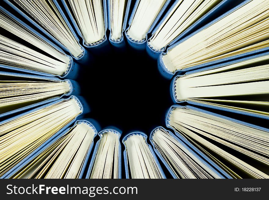 Full frame background with group of blue books organized in circle