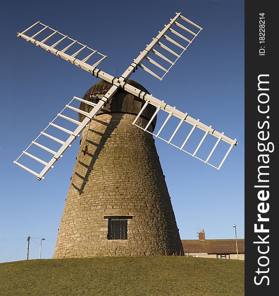 Photograph of a windmill, a traditional form of renewable energy. Photograph of a windmill, a traditional form of renewable energy.