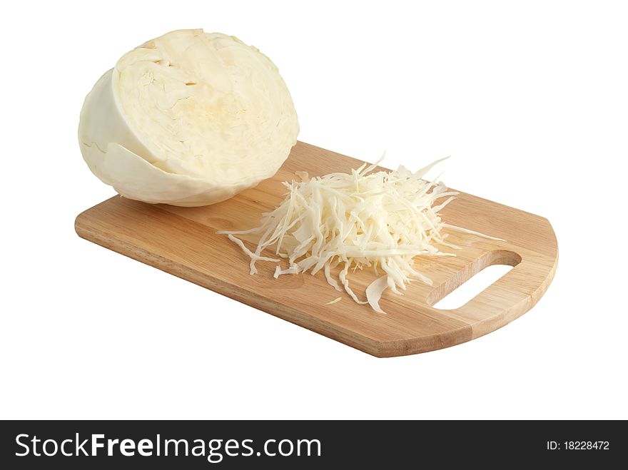 Half of head of cabbage and the chopped leaves of cabbage on a chopping board. On a white background. Half of head of cabbage and the chopped leaves of cabbage on a chopping board. On a white background