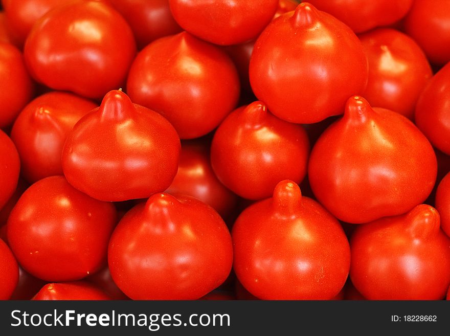 Fresh tomatoes, neatly arranged in a box.