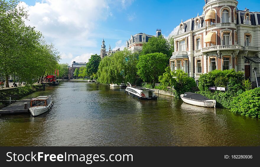 Traditional canal in old center of Amsterdam, Holland. Beauty of old european city centre. Cityscape in spring at sunny day.