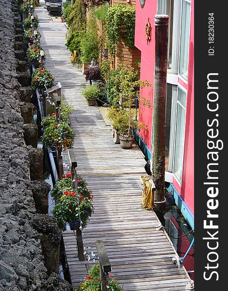 Wooden deck walkway along houseboats. Wooden deck walkway along houseboats