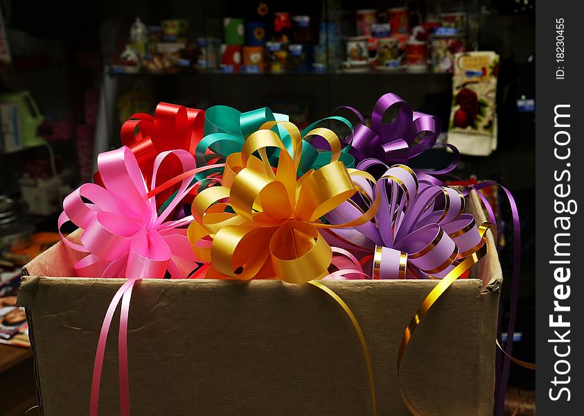 Colorful bows for gifts in a big box