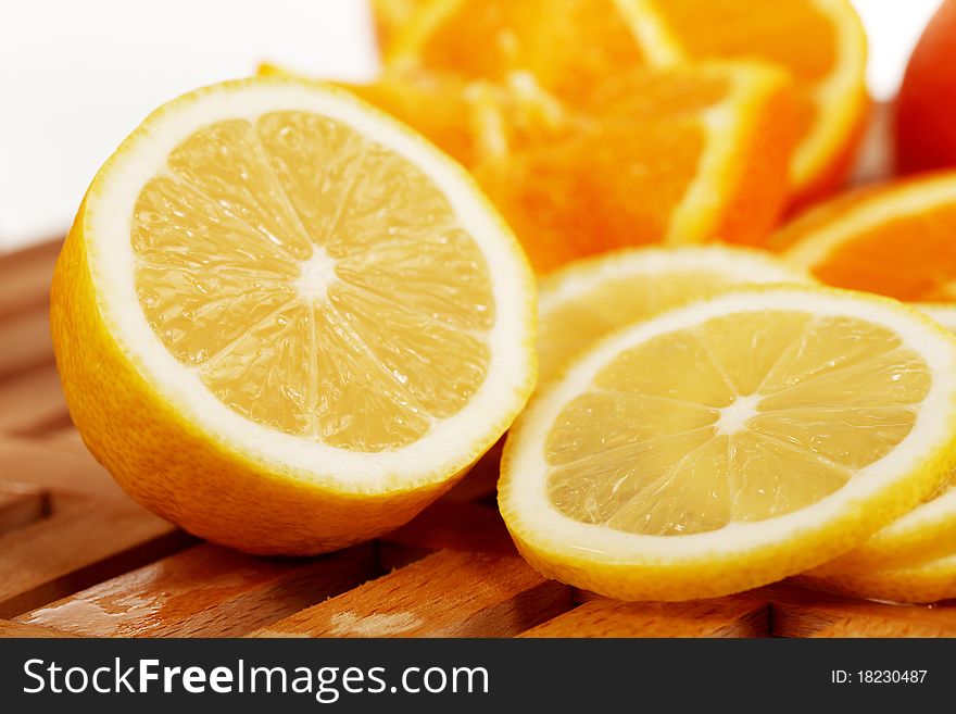 Lemon slices with oranges in the background