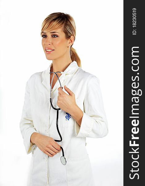 Nurse standing and smiling with the stethoscope in her hands. Nurse standing and smiling with the stethoscope in her hands