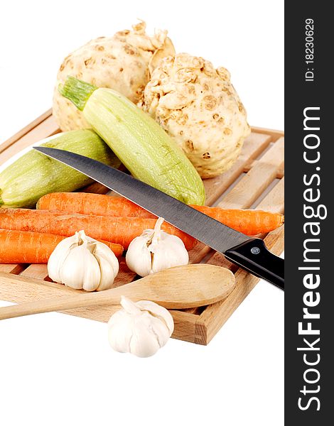 Vegetable mix and knife on a wooden plate. Vegetable mix and knife on a wooden plate