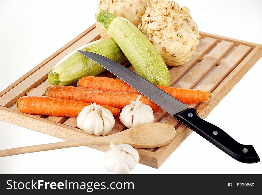 Vegetable mix and knife on a wooden plate