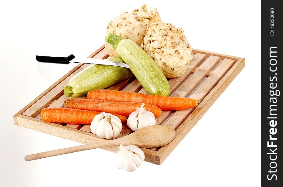 Vegetable mix and knife on a wooden plate. Vegetable mix and knife on a wooden plate
