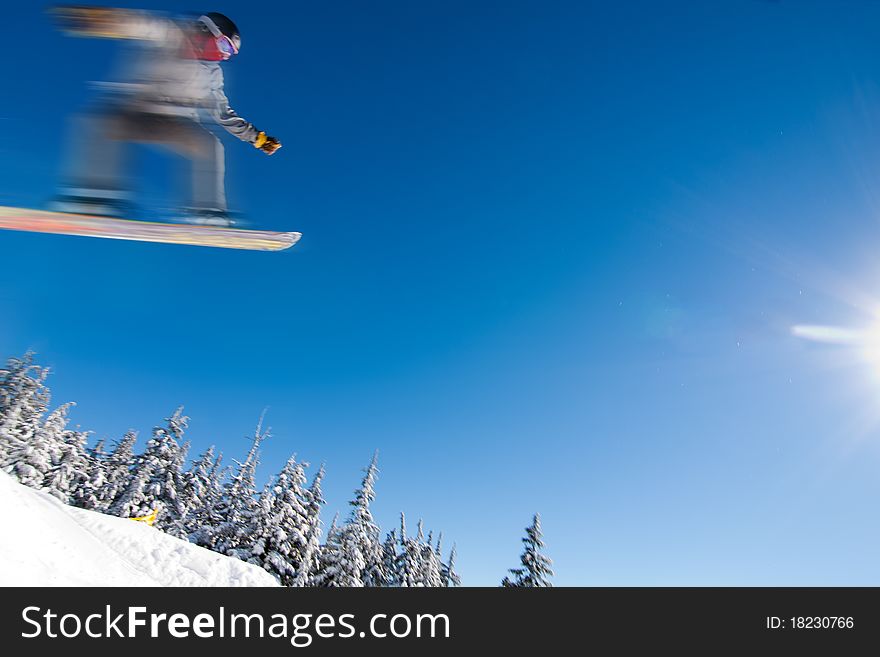 Male Snowboarder Catches Big Air on a Bright Sunny Day. Male Snowboarder Catches Big Air on a Bright Sunny Day.