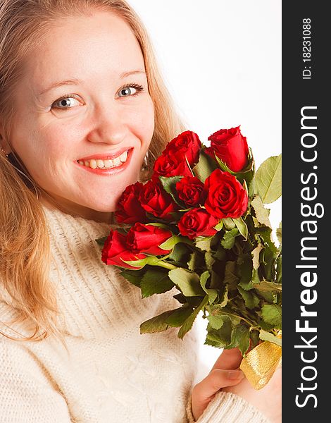 Beautiful young woman with the bouquet of red roses
