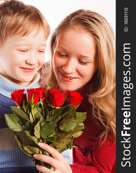 Charming  beautiful young woman with a son and with the bouquet of red roses on a white background