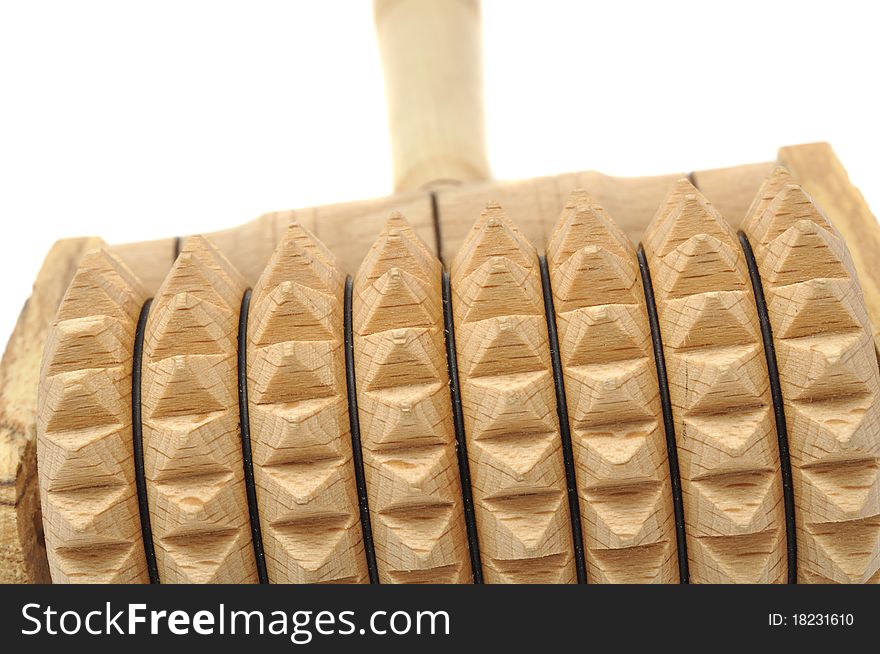 A handheld wooden massager on a white background