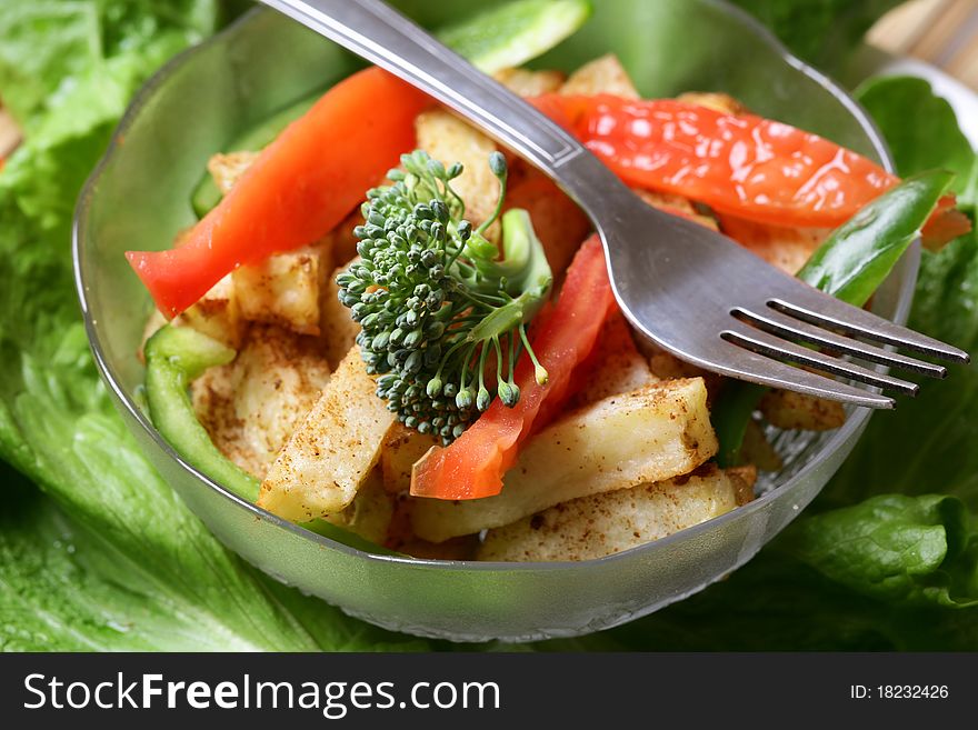 Bowl of potato salad with steel fork.