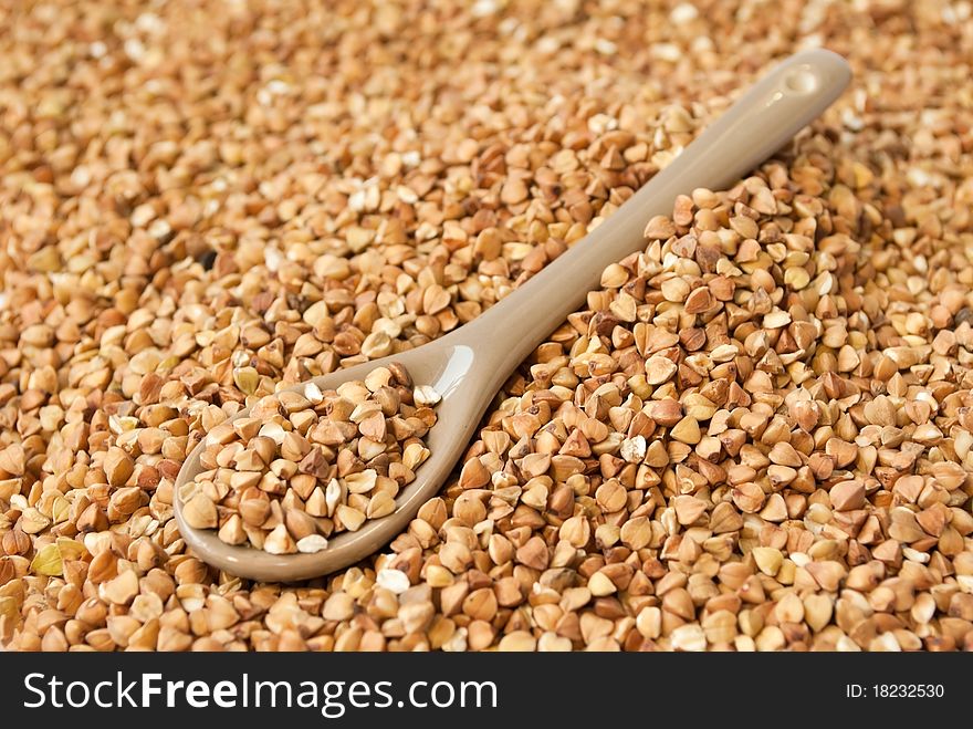 Buckwheat in little brown spoon. Buckwheat in little brown spoon