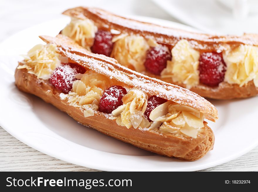 Cake with a raspberry, whipped cream and a peanut