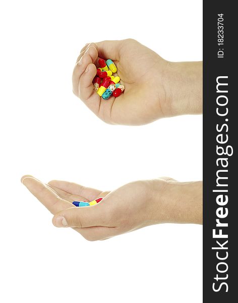 Finger holds pill isolated on white