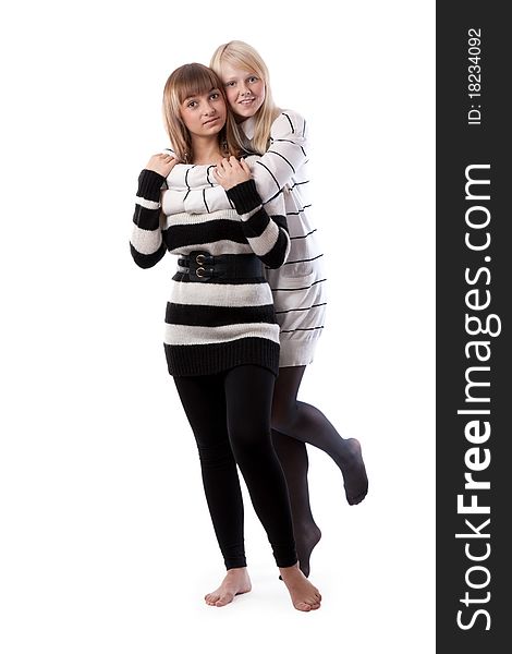 Two friends in striped jackets cuddling on white background