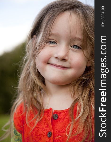 Gorgeous little girl looking straight into camera with a shy smile. Gorgeous little girl looking straight into camera with a shy smile