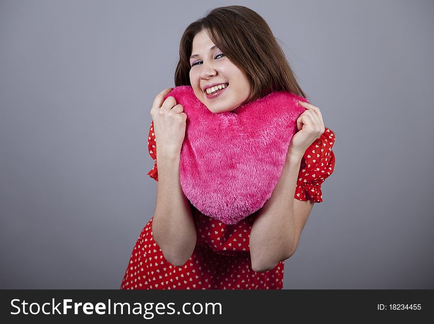 Beautiful girl with heart. Studio shot.