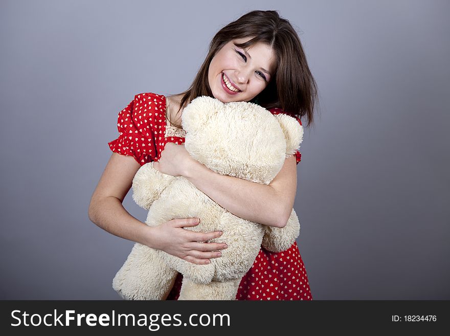 Funny girl with teddy bear. Studio shot.