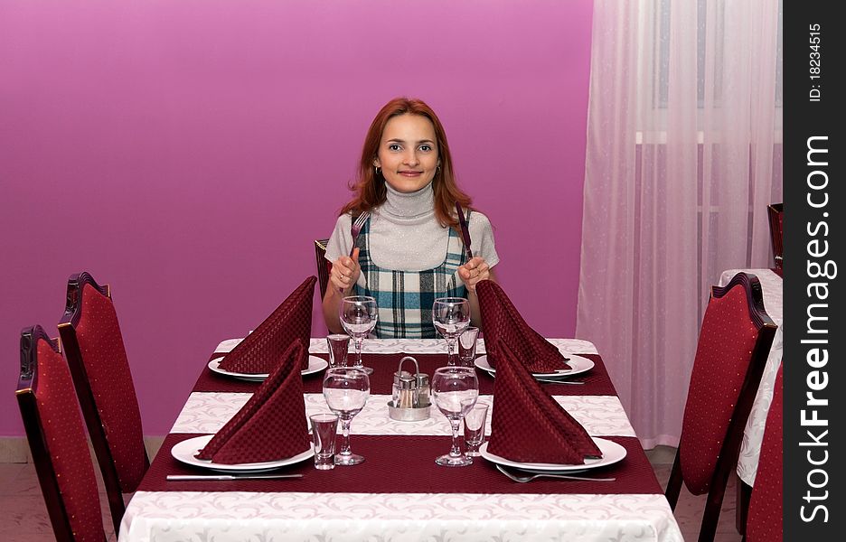 Beautiful girl in a restaurant with a purple design