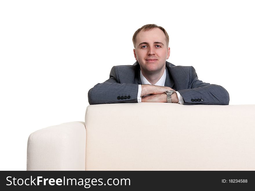 Businessman looking out over the sofa on a white background