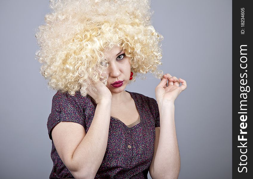 Funny girl in wig. Studio shot.